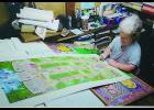 Carolyn Blattel-Britton is shown working on the Iowa Firefighters Memorial drawing she completed in 2012. Blattel-Britton recently died unexpectedly at the age of 64.