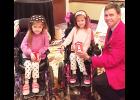 Iowa Firefighters Association President Mark McNees is shown presenting IFA banks to Aimee and Ashley martin, who were both promoting MDA awareness at the IFA Mid Year meeting.